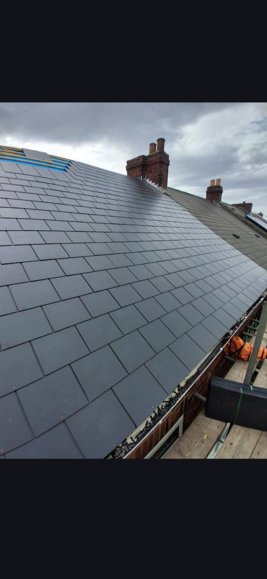 Close-up of new natural slate roof installation